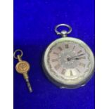 AN ORNATE LADIES SILVER FOB WATCH WITH KEY
