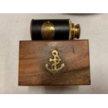 A BOXED BRASS AND LEATHER MARINE TELESCOPE - 20CMS LONG WHEN EXTENDED
