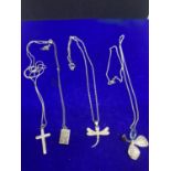 FOUR SILVER NECKLACES WITH PENDANTS TO INCLUDE A FLOWER, DRAGON FLY, LOCKET AND CROSS MARKED 925 /