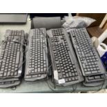 A QUANTITY OF COMPUTER KEYBOARDS AND MOUSE MATS