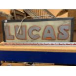 AN ILLUMINATED "LUCAS" SIGN