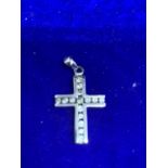 A 9 CARAT WHITE GOLD CROSS IN A PRESENTATION BOX