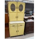 A VINTAGE VIVID YELLOW KITCHEN CABINET WITH GLAZED UPPER DOOR, FOUR CUPBOARDS, TWO DRAWERS AND