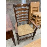 AN 18TH CENTURY STYLE LADDERBACK RUSH SEATED ELBOW CHAIR