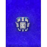 A LARGE RECTANGULAR BLUE AND CLEAR STONE ART DECO STYLE DRESS RING