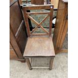 A 19TH CENTURY OAK SINGLE DINING CHAIR WITH 'X' FRAME BACK AND SOLID SEAT