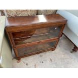 A GLOBE WERNICKE MAHOGANY BOOKCASE WITH TWO UP AND OVER DOORS (ONE REQUIRES RE-GLAZING)