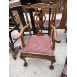 A MAHOGANY CHIPPENDALE STYLE ELBOW CHAIR ON CABRIOLE LEGS, WITH BALL AND CLAW FEET