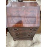 A REPRODUCTION MAHOGANY FALL FRONT BUREAU WITH FOUR DRAWERS BELOW AND FITTED INTERISOR WITH