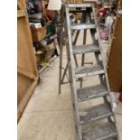 A VINTAGE SET OF METAL STEP LADDERS