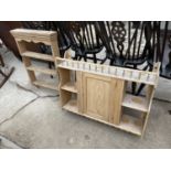 A PINE WALL CABINET ENCLOSING CHAIRS AND OPEN SHELVES