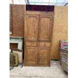 A LARGE WOODEN CUPBOARD ENCLOSING UPPER CUPBOARD, TWO SHORT DRAWERS AND LOWER CUPBOARDS