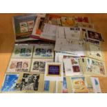 A LARGE QUANTITY OF FIRST DAY STAMPS AND POSTCARDS FEATURING 'THE MILLENNIUM COLLECTION' AND 'HER