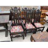 A SET OF SIX JACOBEAN STYLE DINING CHAIRS WITH FOLIATE CARVING TO THE BACK, SOLID SEATS AND TURNED
