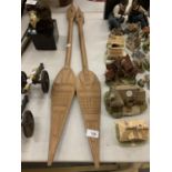 A PAIR OF CARVED WOODEN PADDLES