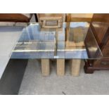 A GLASS TOP COFFEE TABLE ON 'X' FRAME BASE