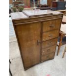 A SHINY WALNUT TALLBOY ENCLOSING HANGING COMPARTMENT AND FIVE DRAWERS, WITH LIFT-UP MIRROR 33" WIDE