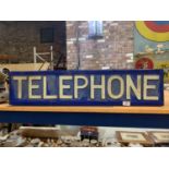 AN ILLUMINATED LIGHT BOX 'TELEPHONE' SIGN