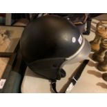 A BLACK MOTORCYCLE HELMET WITH PEAK MADE IN ITALY