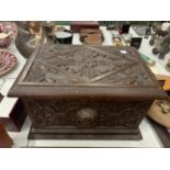 A VINTAGE HEAVILY CARVED WOODEN BOX