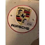 A CAST METAL ?PORSCHE? RACING CAR CIRCULAR SIGN