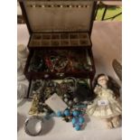 A JEWELLERY BOX WITH COSTUME JEWELLERY AND A PORCELAIN DOLL