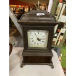 A WOODEN CASED ORNATE CLOCK