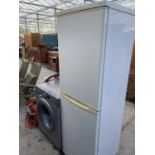 A WHITE HOOVER UPRIGHT FRIDGE FREEZER BELIEVED IN WORKING ORDER BUT NO WARRANTY
