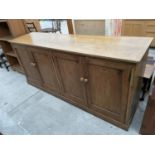 A LARGE PINE KITCHEN CABINET WITH FOUR DOORS