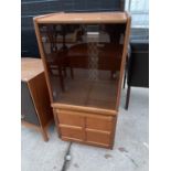 A NATHAN RETRO TEAK CABINET WITH LOWER DOOR AND UPPER SMOKED GLASS DOOR