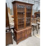 A 19TH CENTURY STYLE TWO DOOR GLAZED BOOKCASE ON OGEE FEET, WITH CUPBOARDS TO THE BASE, 40" WIDE (