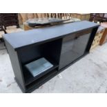 A MODERN EBONISED LOW LOUNGE UNIT WITH GLASS DOORS AND SHELVING, 80" WIDE