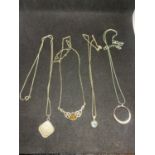 FOUR SILVER NECKLACES MARKED 925 WITH PENDANTS TO INCLUDE A CLEAR STONE CIRCLE, A CELTIC DESIGN, A