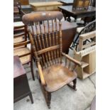 A VICTORIAN ELM ROCKING CHAIR WITH SPINDLE BACK, TURNED LEGS AND STRETCHERS