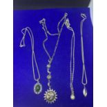 FOUR SILVER NECKLACES MARKED 925 WITH PENDANTS TO INCLUDE MOON AND SUN, PEARL, GREEN STONE AND
