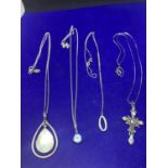 FOUR SILVER NECKLACES MARKED 925 WITH PENDANTS TO INCLUDE A CROSS, TEARDROP STYLE, BLUE STONE AND AN