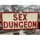 AN ILLUMINATED 'SEX DUNGEON' SIGN