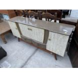 A RETRO CREAMY WALNUT EFFECT SIDEBOARD/COCTAIL CABINET, ENCLOSING FOUR CUPBOARDDS AND TWO DRAWERS,