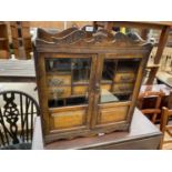 A LATE VICTORIAN TWO DOOR GLAZED TOBACCO CABINET ENCLOSING SHELVES, SEVEN DRAWERS AND SIX DIVISION