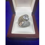A HEAVY SILVER RING MARKED 925 WITH TWO LARGE HEART STONES AND CLEAR STONE CHIPS ON THE SHOULDERS
