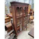 A VICTORIAN MAHOGANY TWO DOOR GLAZED BOOKCASE ON CABRIOLE LEGS, 37.5" WIDE