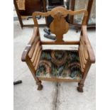 AN EARLY 20TH CENTURY WALNUT FRAMED LOW ELBOW CHAIR ON TURNED BULBOUS LEGS AND SCROLL FEET