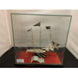 A WHITE METAL POSSIBLY SILVER MODEL OF A CHINESE JUNK IN A GLASS PRESENTATION CASE