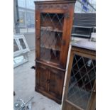 A PRIORY STYLE OAK CORNER CABINET WITH TWO LOWER DOORS AND A LEAD GLAZED UPPER DOOR