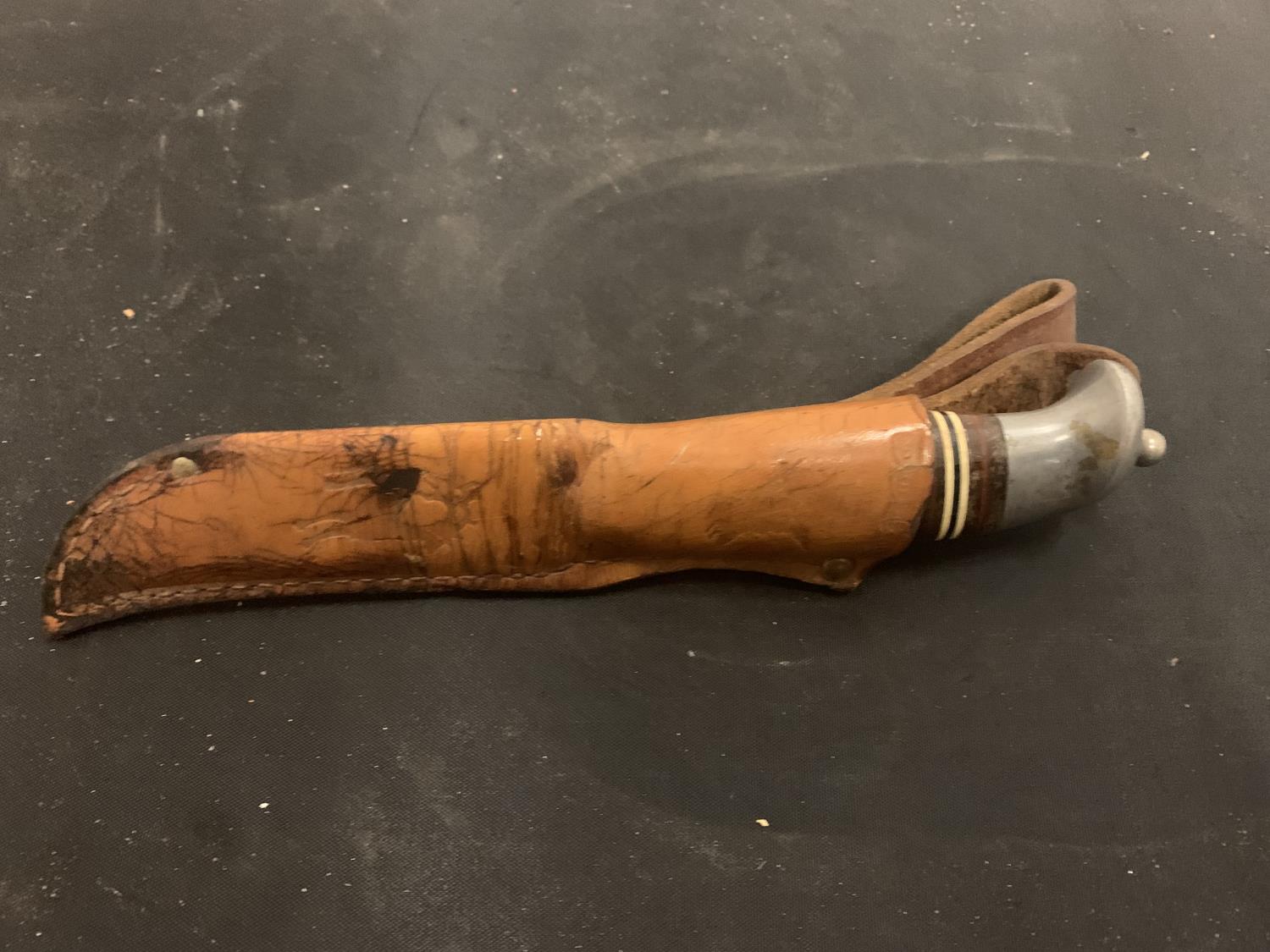 A KNIFE WITH DECORATED HANDLE AND LEATHER SHEATH