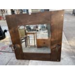 A RUSTIC PINE MIRROR WITH SIDE CANDLE HOLDERS