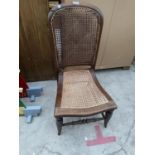 A MAHOGANY NURSING CHAIR WITH RATTAN SEAT AND BACK