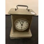 A METAL CASED CARRIAGE CLOCK WITH BRASS DETAIL