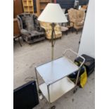 A GILT STANDARD LAMP AND A FURTHER TUBULAR METAL DINNER TROLLEY