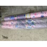 THREE ROLLS OF PINK AND FLORAL MATERIAL